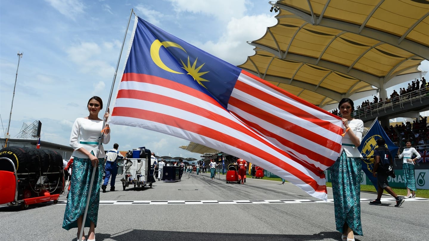 Grid girls with Malaysian flag on the grid at Formula One World Championship, Rd2, Malaysian Grand