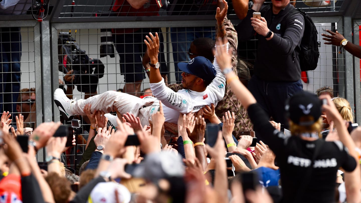 Lewis Hamilton (GBR) Mercedes AMG F1 celebrates with the fans by crowdsurfing at Formula One World