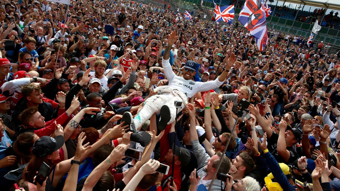 Race winner celebrates with the fans by crowdsurfing at Formula One World Championship, Rd10,