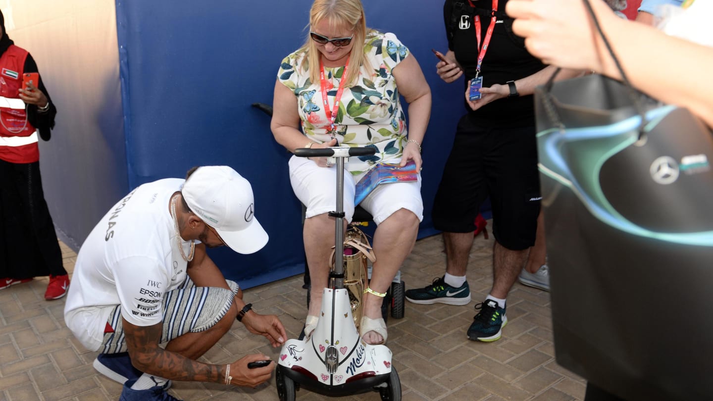 Lewis Hamilton (GBR) Mercedes AMG F1 signs a mobility scooter at Formula One World Championship, Rd20, Abu Dhabi Grand Prix, Preparations, Yas Marina Circuit, Abu Dhabi, UAE, Thursday 23 November 2017. © Simon Galloway/Sutton Images