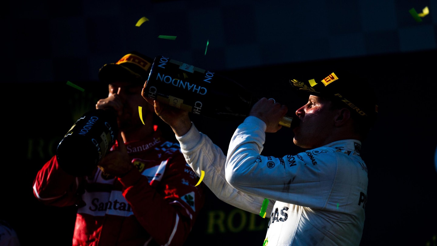 Sebastian Vettel (GER) Ferrari and Valtteri Bottas (FIN) Mercedes AMG F1 celebrate on the podium with the champagne at Formula One World Championship, Australian Grand Prix, Race, Melbourne, Australia, Sunday 26 March 2017. © Sutton Motorsport Images