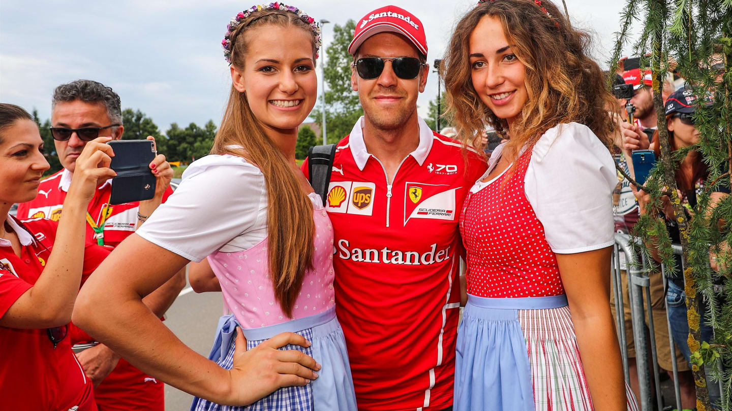 Sebastian Vettel (GER) Ferrari and girls at Formula One World Championship, Rd9, Austrian Grand Prix, Qualifying, Spielberg, Austria, Saturday 8 July 2017. © Sutton Images
