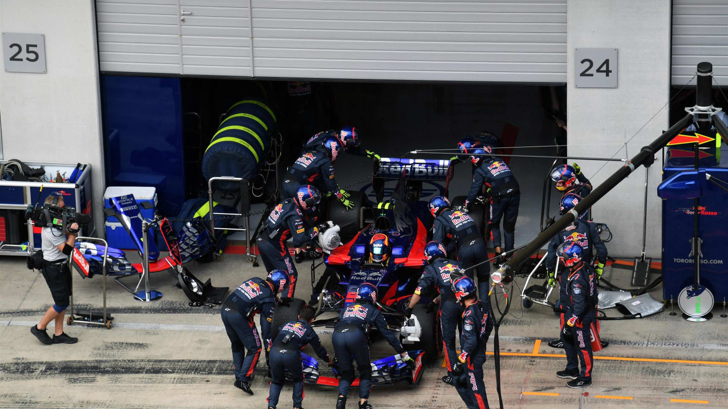 The car of race retiree Carlos Sainz (ESP) Scuderia Toro Rosso STR12 is pushed back into the garage by mechanics at Formula One World Championship, Rd9, Austrian Grand Prix, Race, Spielberg, Austria, Sunday 9 July 2017. © Sutton Images