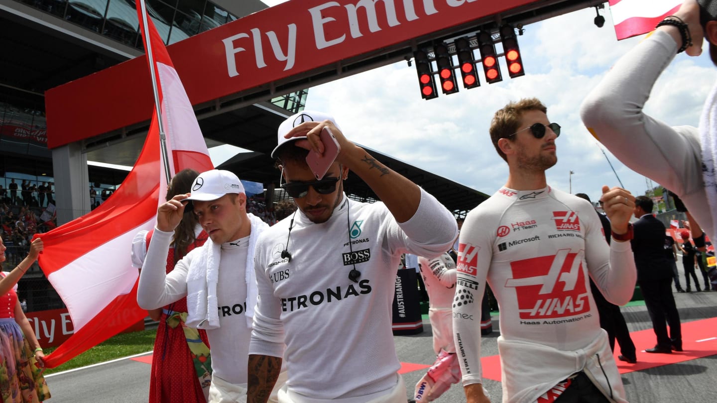 Valtteri Bottas (FIN) Mercedes AMG F1, Lewis Hamilton (GBR) Mercedes AMG F1 and Romain Grosjean (FRA) Haas F1 on the grid on the grid at Formula One World Championship, Rd9, Austrian Grand Prix, Race, Spielberg, Austria, Sunday 9 July 2017. © Sutton Images