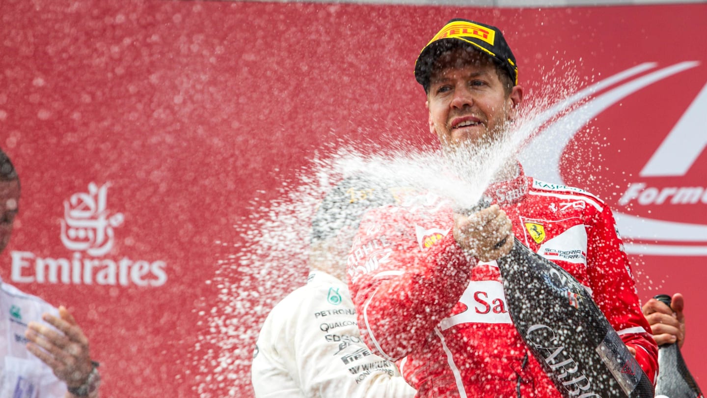 Sebastian Vettel (GER) Ferrari celebrates on the podium with the champagne at Formula One World Championship, Rd9, Austrian Grand Prix, Race, Spielberg, Austria, Sunday 9 July 2017. © Sutton Images