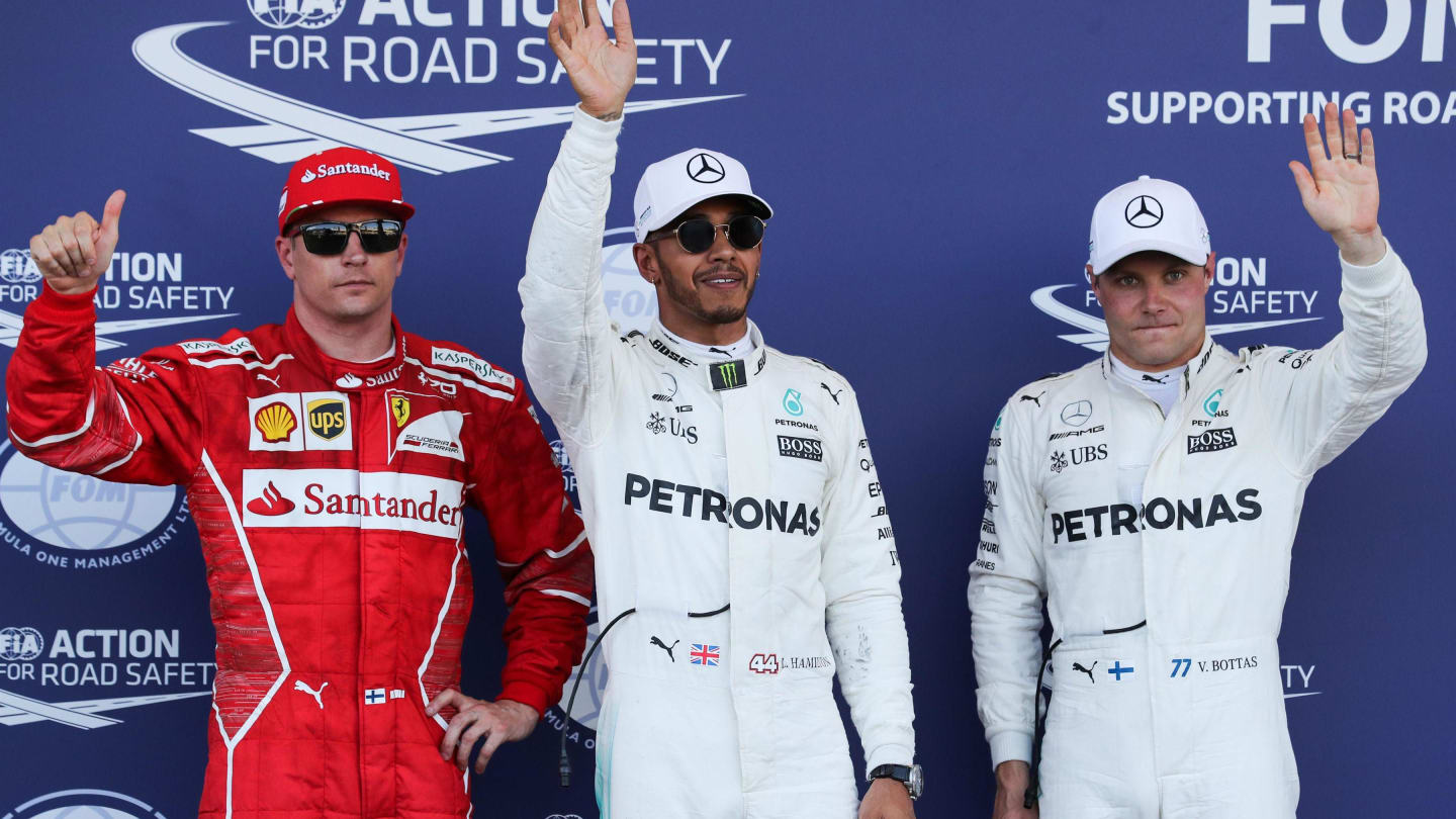 (L to R): Kimi Raikkonen (FIN) Ferrari, pole sitter Lewis Hamilton (GBR) Mercedes AMG F1 and