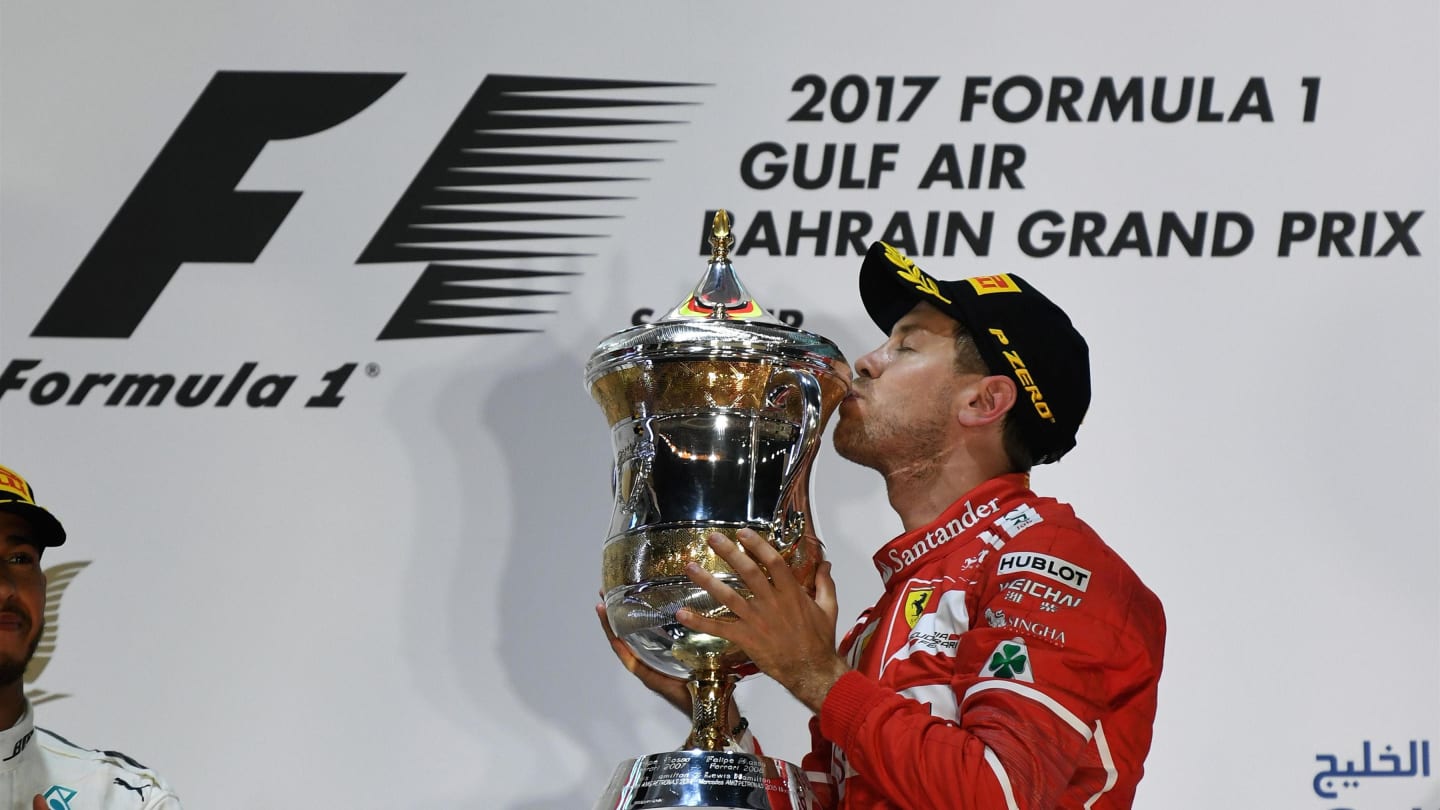 Race winner Sebastian Vettel (GER) Ferrari celebrates on the podium with the trophy at Formula One World Championship, Rd3, Bahrain Grand Prix Race, Bahrain International Circuit, Sakhir, Bahrain, Sunday 16 April 2017. © Sutton Motorsport Images