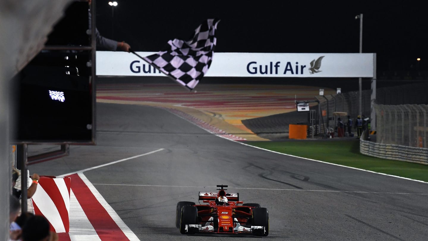 Race winner Sebastian Vettel (GER) Ferrari SF70-H takes the chequered flag at Formula One World Championship, Rd3, Bahrain Grand Prix Race, Bahrain International Circuit, Sakhir, Bahrain, Sunday 16 April 2017. © Sutton Motorsport Images