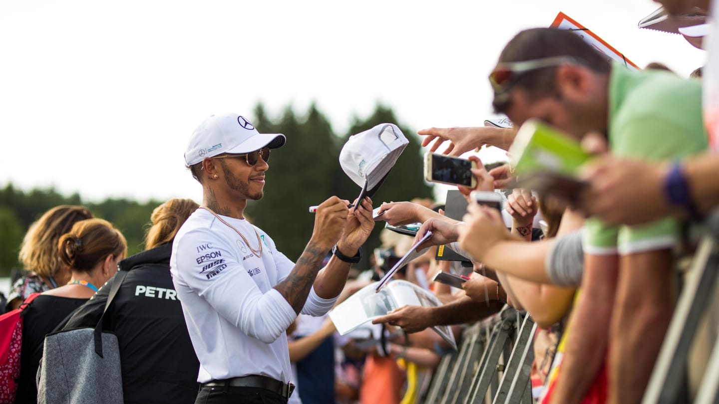 Lewis Hamilton (GBR) Mercedes AMG F1 signs autographs for the fans at Formula One World