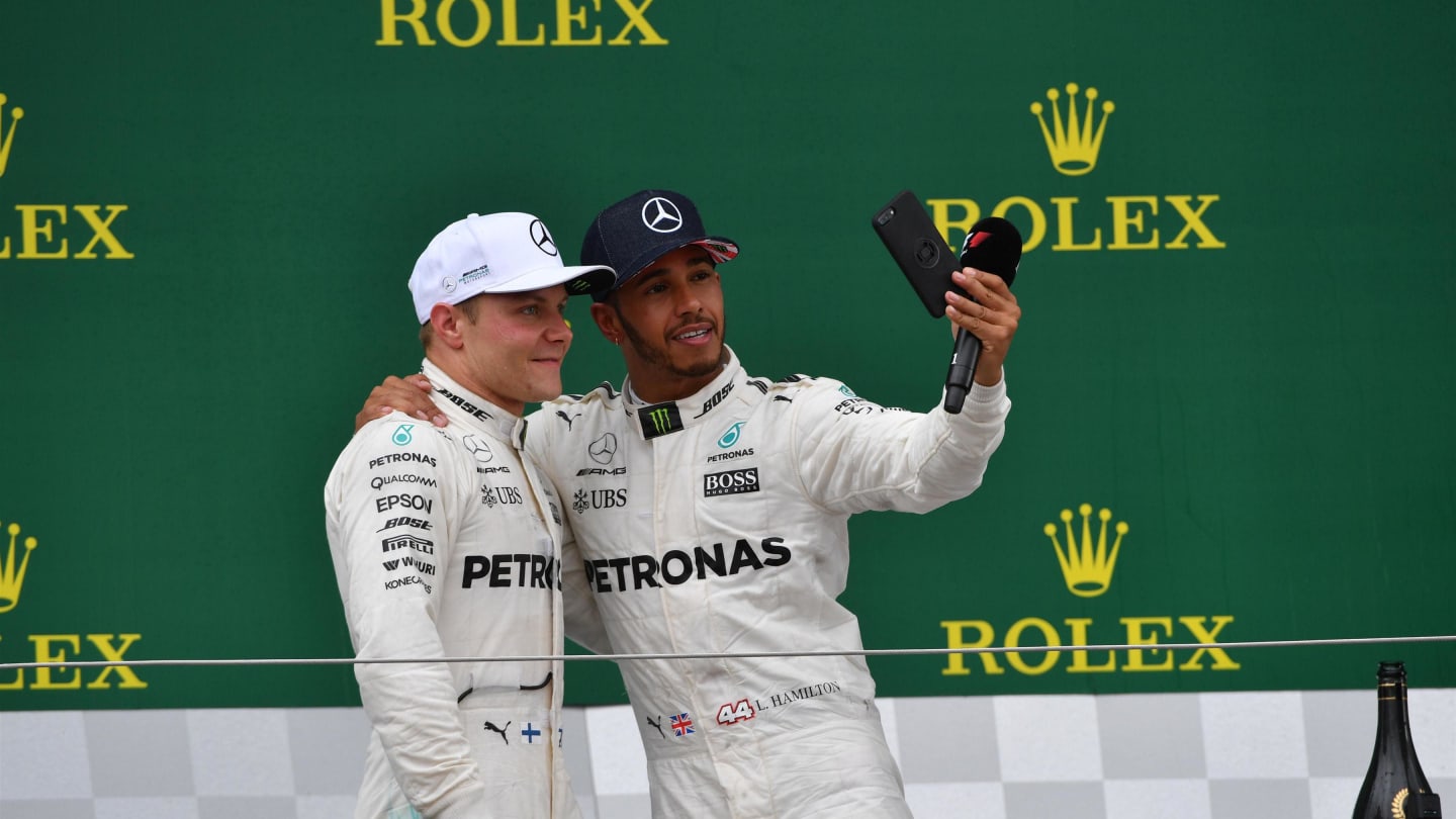 Valtteri Bottas (FIN) Mercedes AMG F1 and Lewis Hamilton (GBR) Mercedes AMG F1 selfie on the podium at Formula One World Championship, Rd10, British Grand Prix, Race, Silverstone, England, Sunday 16 July 2017. © Sutton Images