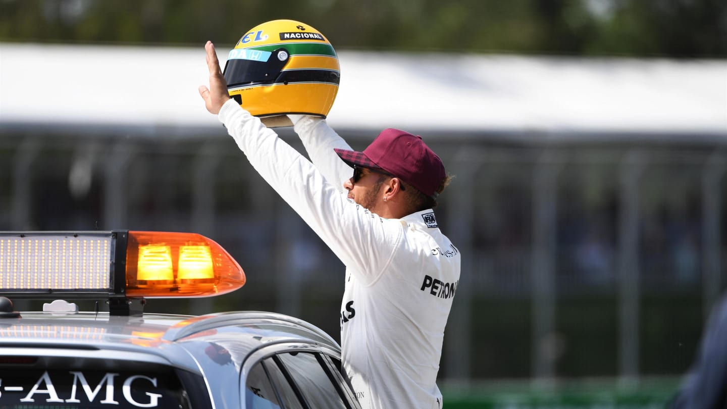 Pole sitter Lewis Hamilton (GBR) Mercedes AMG F1 celebrates on the Medical Car with the helmet of