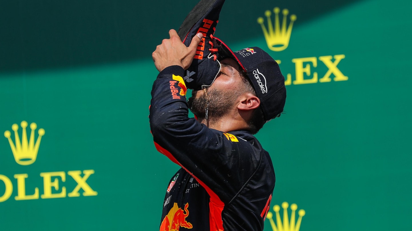 Daniel Ricciardo (AUS) Red Bull Racing celebrates on the podium with the champagne and does a shoey