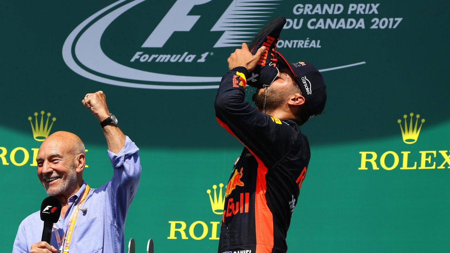 Daniel Ricciardo (AUS) Red Bull Racing does a shoey on the podium watched by Patrick Stewart (GBR)