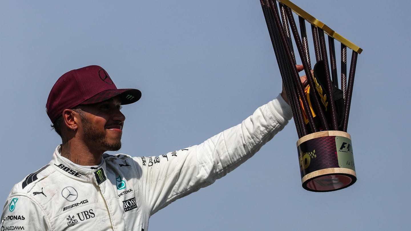 Lewis Hamilton (GBR) Mercedes AMG F1 celebrates on the podium with the trophy at Formula One World