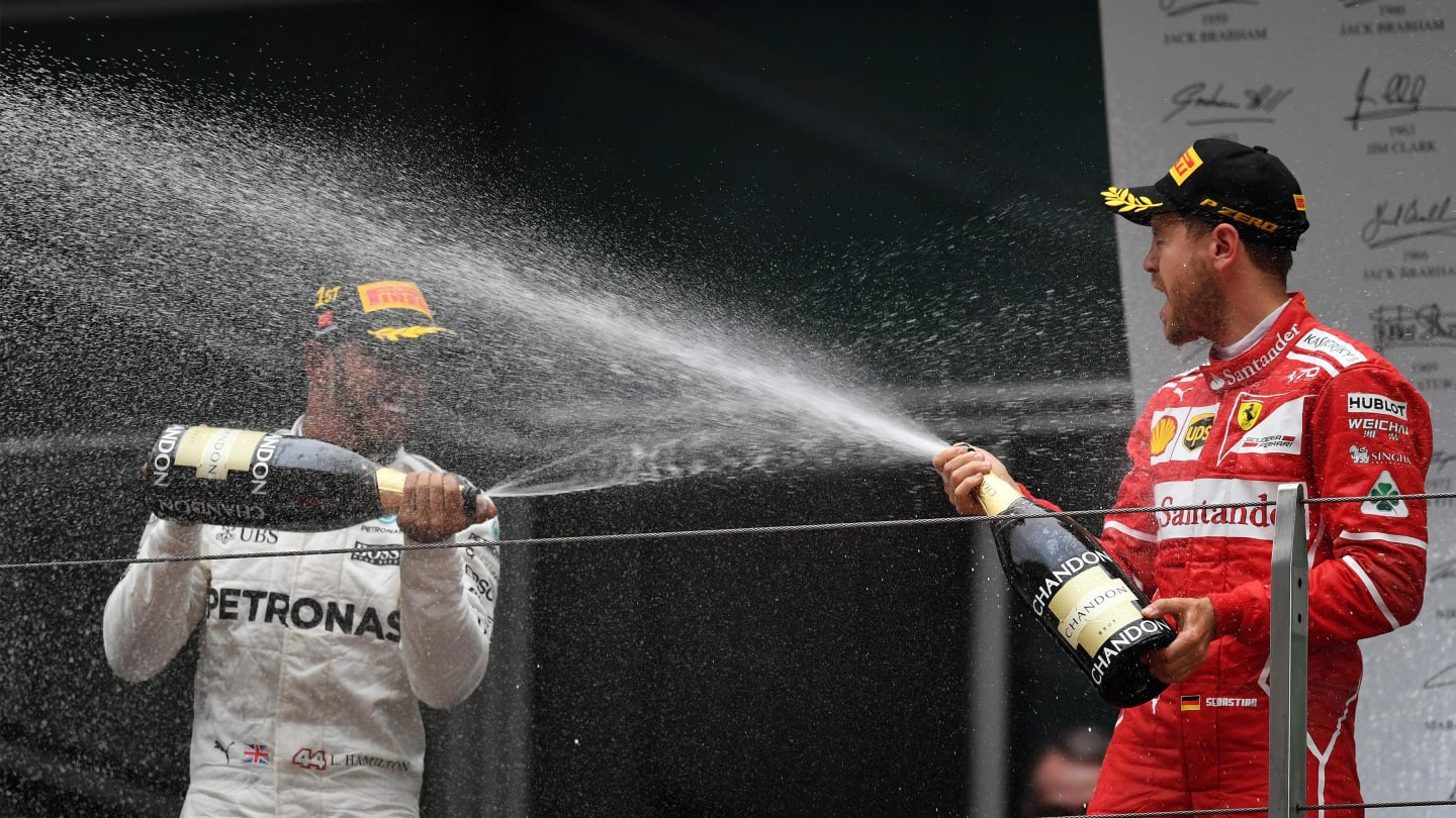 Sebastian Vettel (GER) Ferrari and Lewis Hamilton (GBR) Mercedes AMG F1 celebrate on the podium with the champagne at Formula One World Championship, Rd2, Chinese Grand Prix, Race, Shanghai, China, Sunday 9 April 2017. © Sutton Motorsport Images
