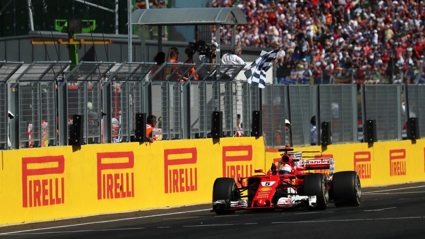 Race winner Sebastian Vettel (GER) Ferrari SF70-H takes the chequered flag at Formula One World Championship, Rd11, Hungarian Grand Prix, Race, Hungaroring, Hungary, Sunday 30 July 2017. © Sutton Images