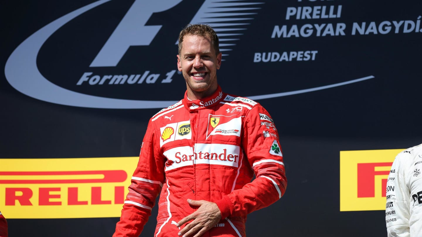 Race winner Sebastian Vettel (GER) Ferrari celebrates on the podium at Formula One World