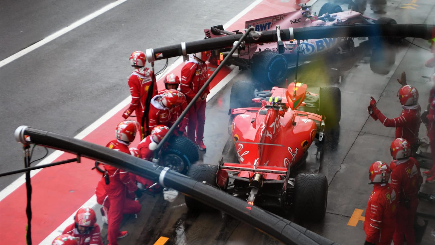 Kimi Raikkonen (FIN) Ferrari SF70-H pit stop and almost collides with Sergio Perez (MEX) Force India VJM10 at Formula One World Championship, Rd13, Italian Grand Prix, Qualifying, Monza, Italy, Saturday 2 September 2017. © Sutton Images