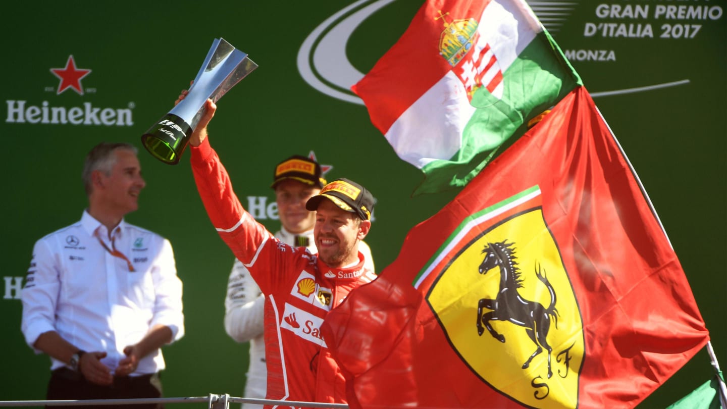 Sebastian Vettel (GER) Ferrari celebrates on the podium with the trophy at Formula One World