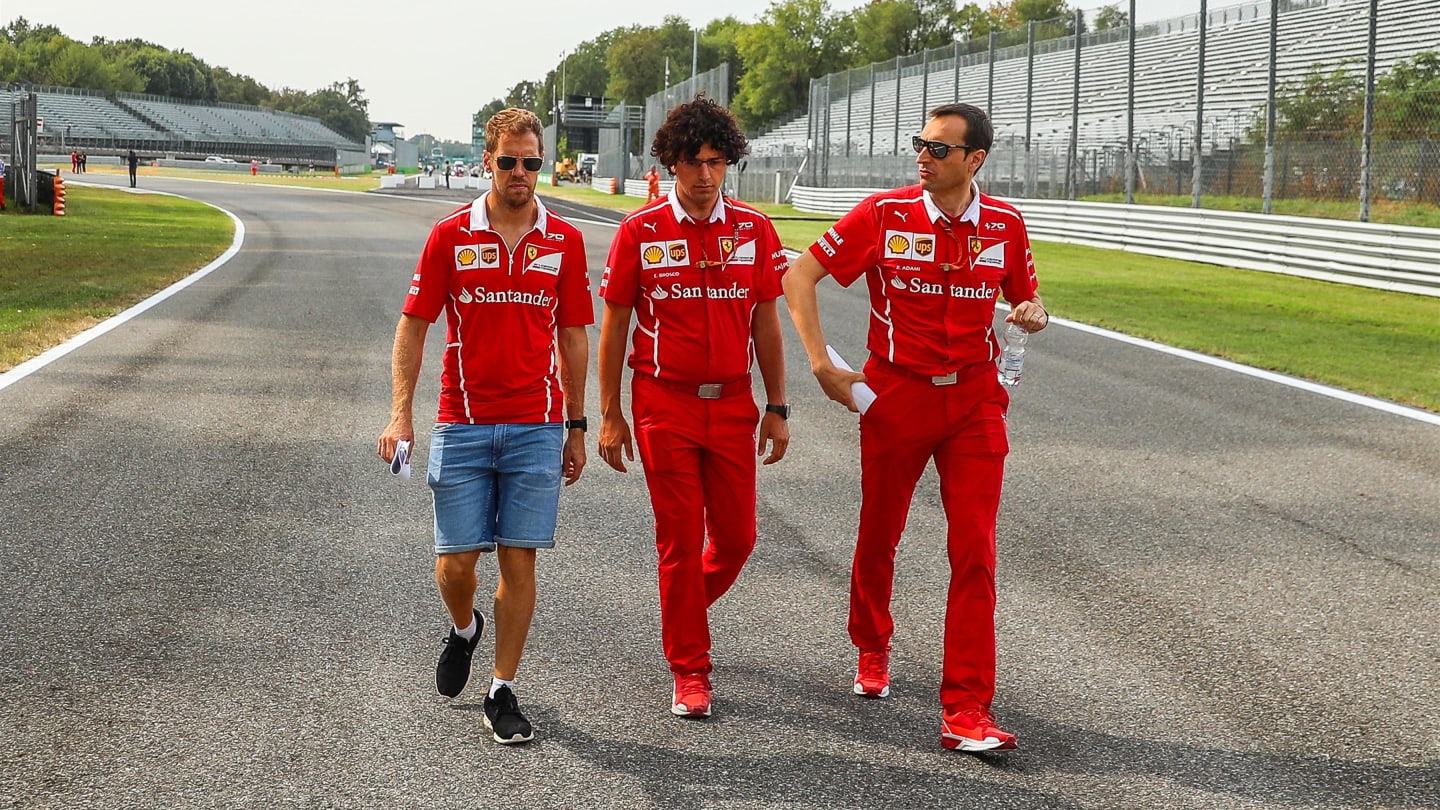 Sebastian Vettel (GER) Ferrari and Riccardo Adami (ITA) Ferrari Race Engineer walk the track at
