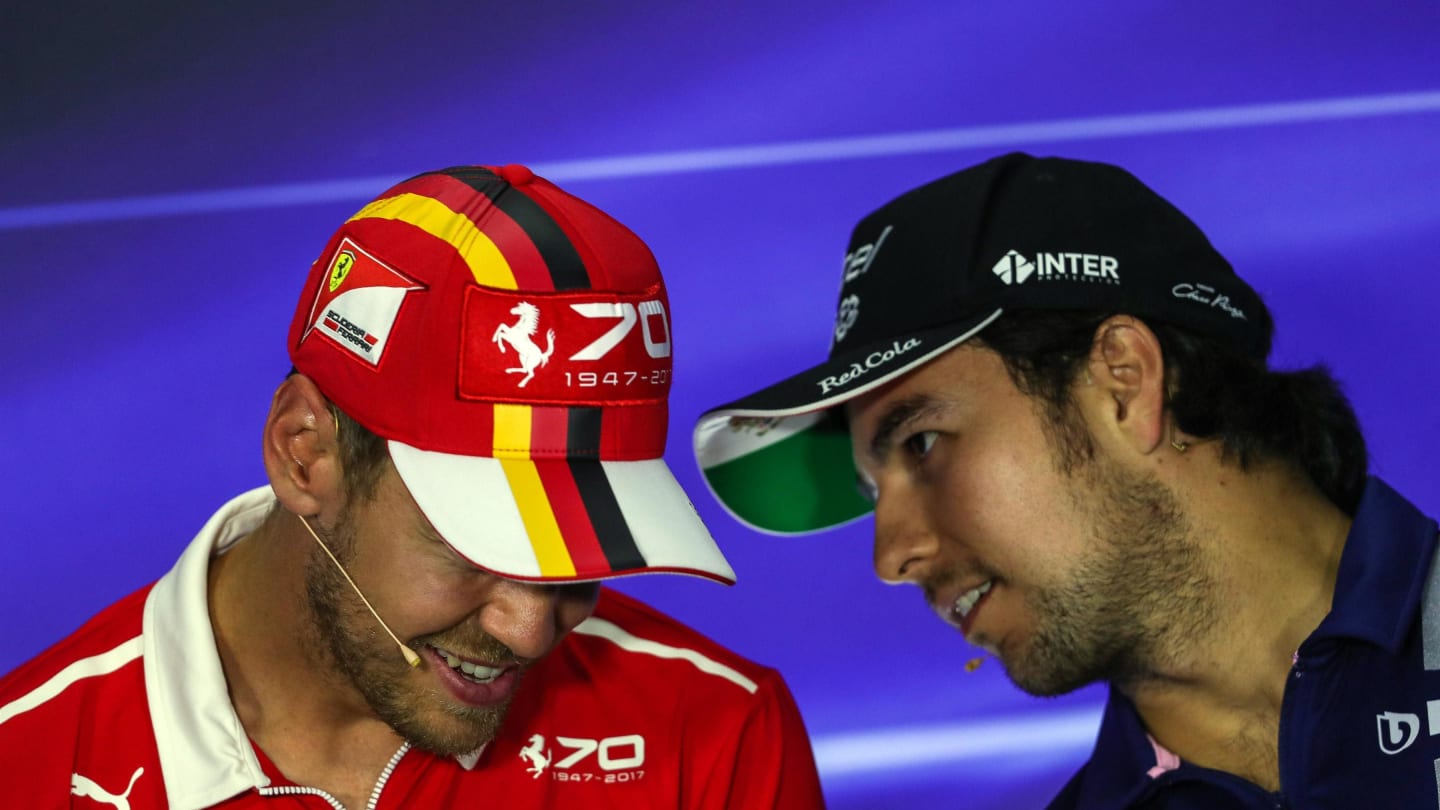 Sebastian Vettel (GER) Ferrari and Sergio Perez (MEX) Force India in the Press Conference at