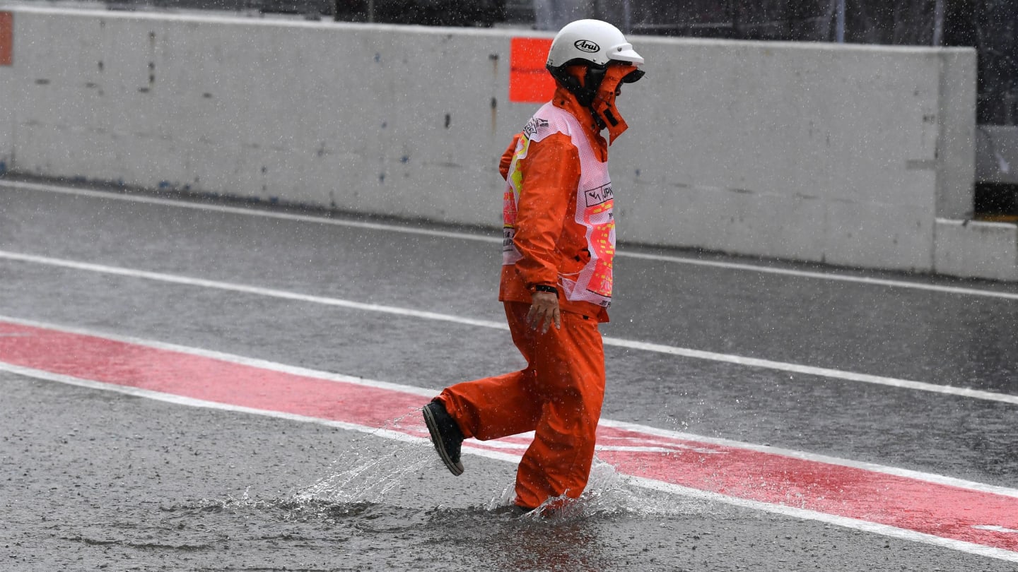 Marshal and flooded pit lane at Formula One World Championship, Rd16, Japanese Grand Prix, Practice, Suzuka, Japan, Friday 6 October 2017. © Mark Sutton/Sutton Images