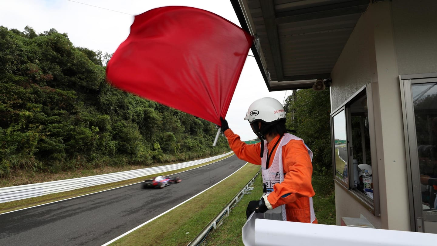 Marshal waves the red flag in FP3 at Formula One World Championship, Rd16, Japanese Grand Prix, Qualifying, Suzuka, Japan, Saturday 7 October 2017. © Kym Illman/Sutton Images