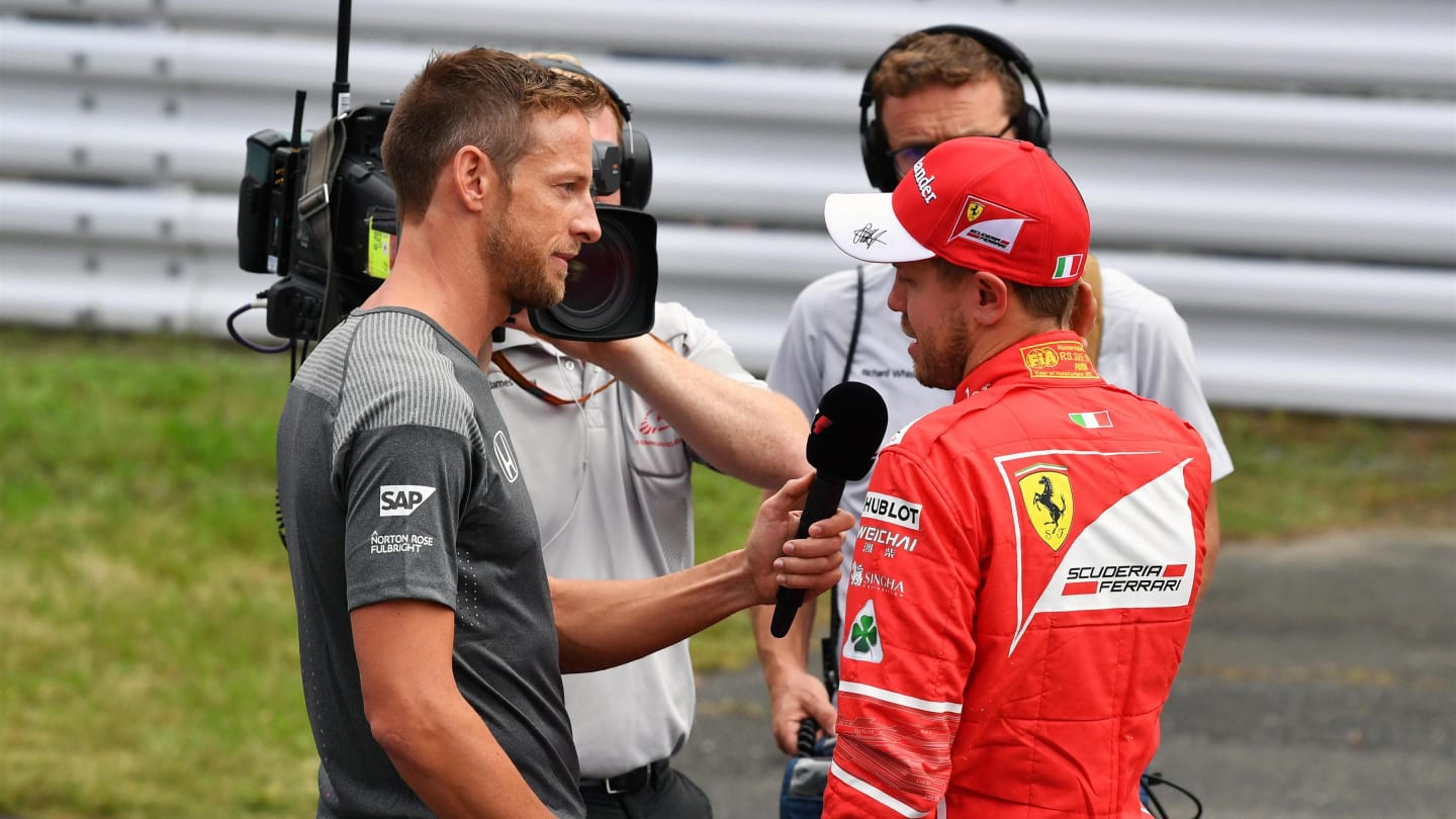 Sebastian Vettel (GER) Ferrari talks with Jenson Button (GBR) in parc ferme at Formula One World