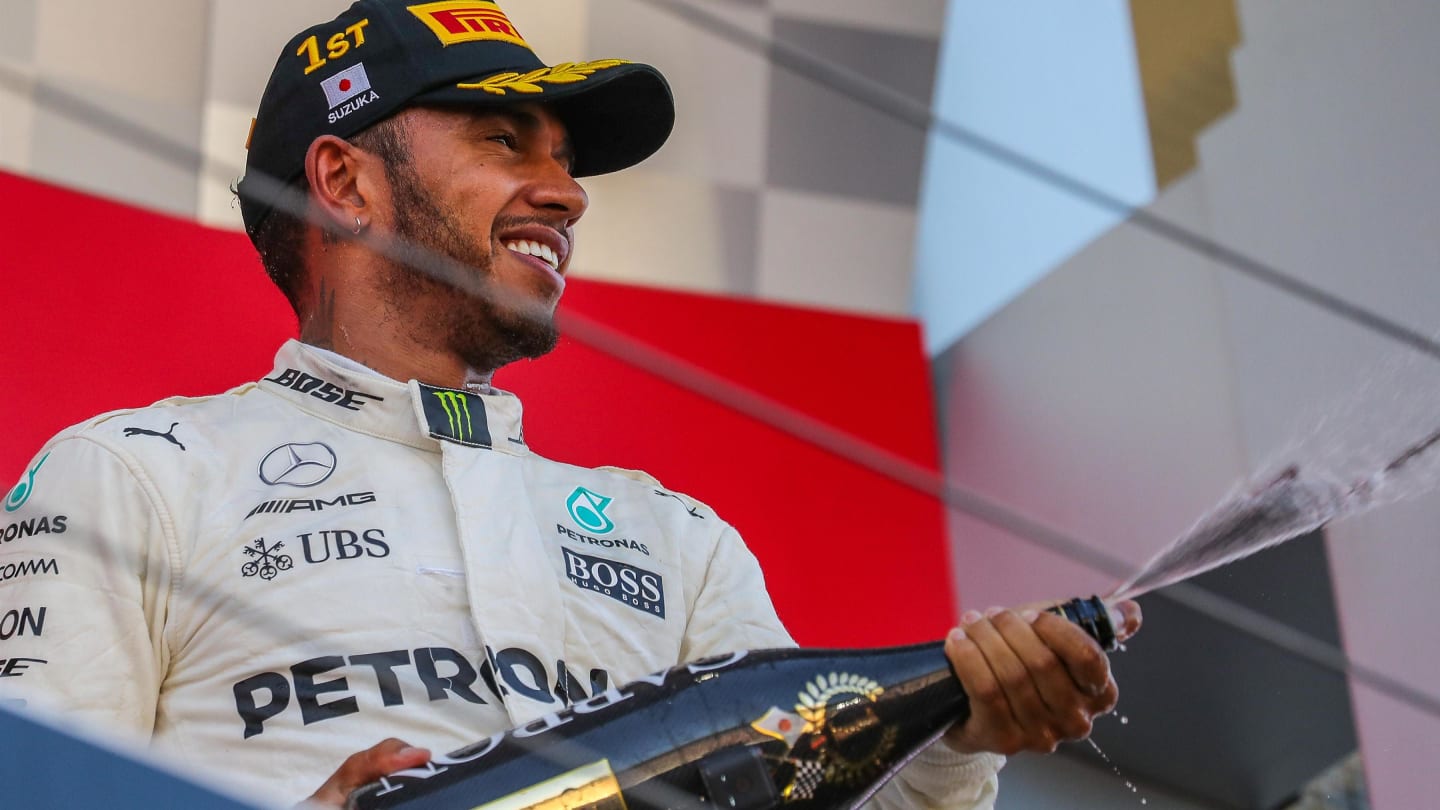 race winner Lewis Hamilton (GBR) Mercedes AMG F1 celebrates on the podium with the champagne at