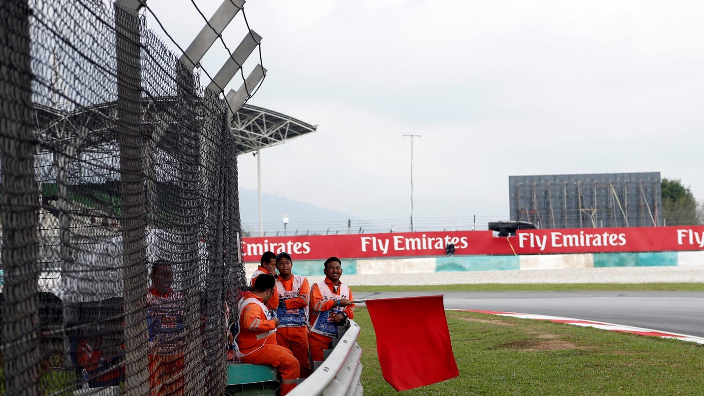 Marshal waves the red flag at Formula One World Championship, Rd15, Malaysian Grand Prix, Practice, Sepang, Malaysia, Friday 29 September 2017. © Manuel Goria/Sutton Images