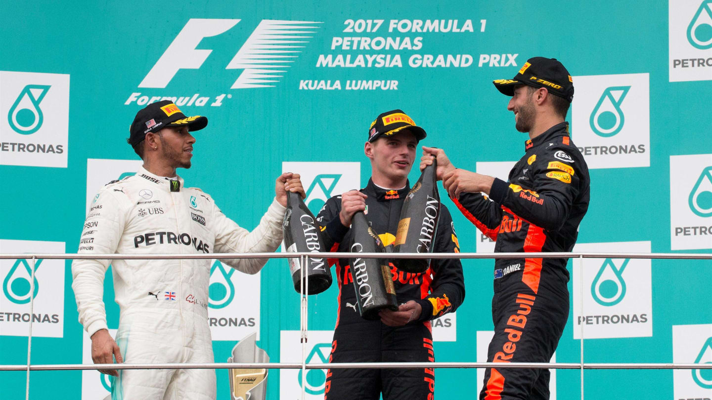 Lewis Hamilton (GBR) Mercedes AMG F1, race winner Max Verstappen (NED) Red Bull Racing and Daniel Ricciardo (AUS) Red Bull Racing celebrate on the podium with the champagne at Formula One World Championship, Rd15, Malaysian Grand Prix, Race, Sepang, Malaysia, Sunday 1 October 2017. © Manuel Goria/Sutton Images