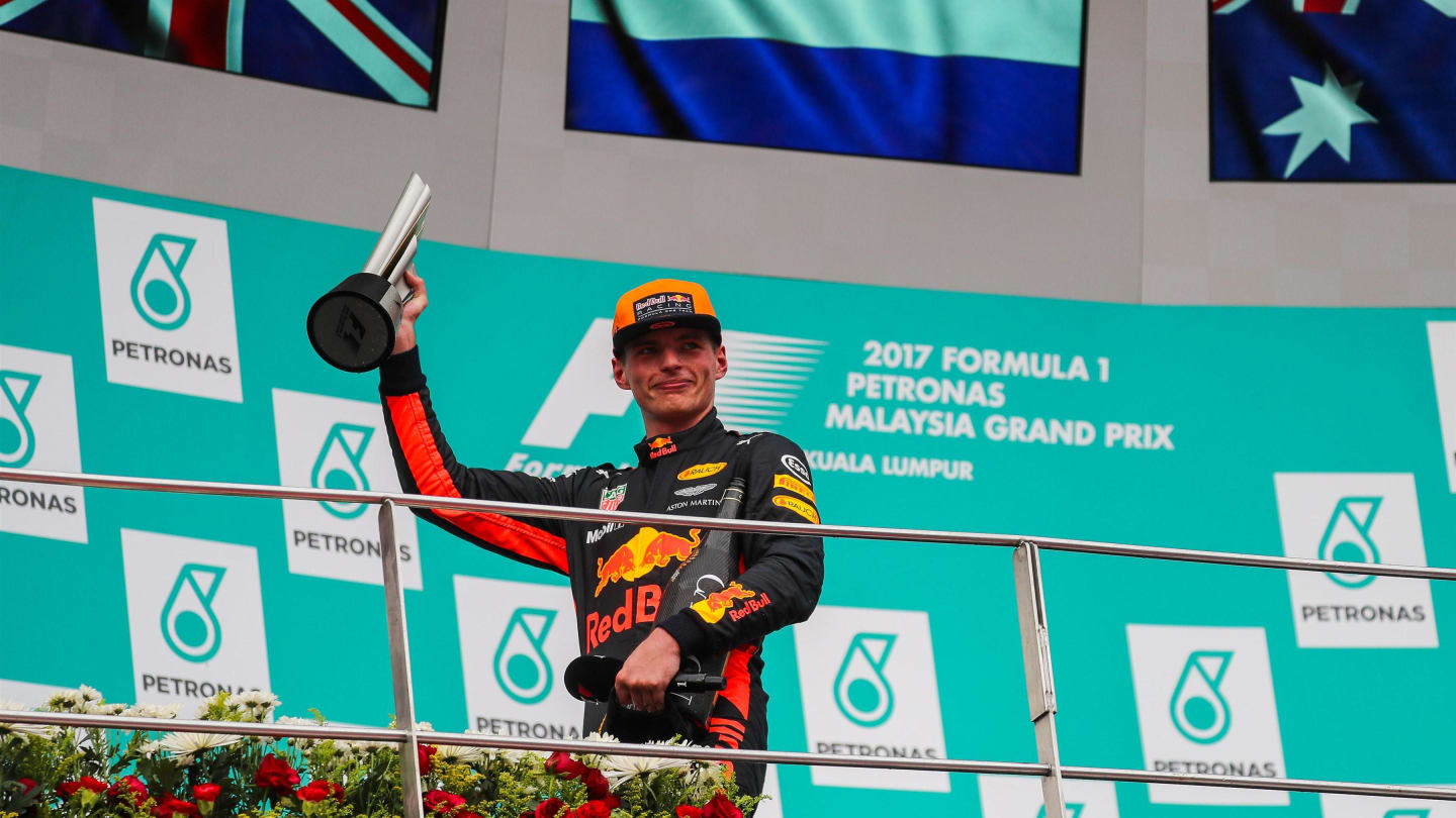Race winner Max Verstappen (NED) Red Bull Racing celebrates on the podium with the trophy and champagne at Formula One World Championship, Rd15, Malaysian Grand Prix, Race, Sepang, Malaysia, Sunday 1 October 2017. © Kym Illman/Sutton Images