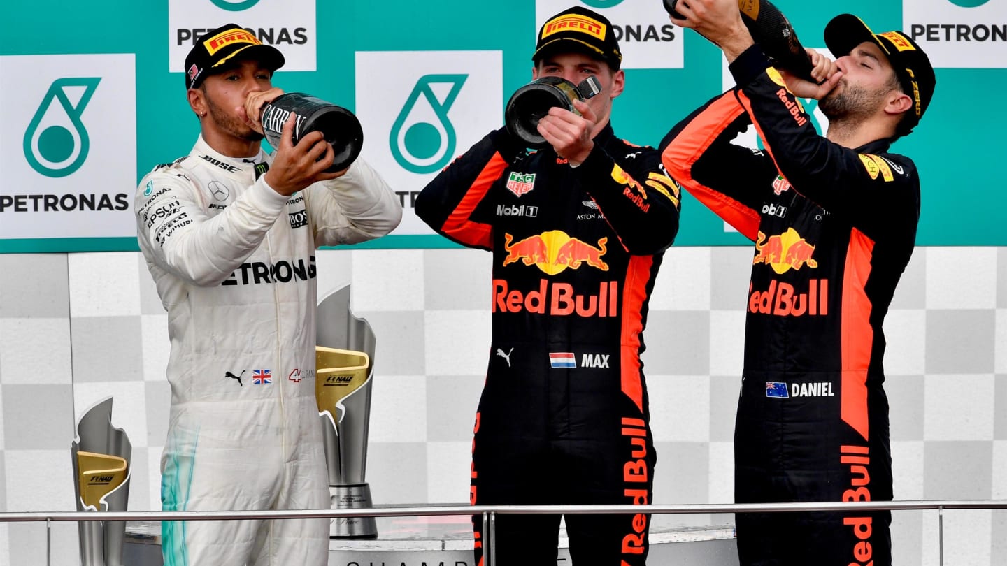 Lewis Hamilton (GBR) Mercedes AMG F1, Max Verstappen (NED) Red Bull Racing and Daniel Ricciardo (AUS) Red Bull Racing celebrate on the podium with the champagne at Formula One World Championship, Rd15, Malaysian Grand Prix, Race, Sepang, Malaysia, Sunday 1 October 2017. © Sutton Images
