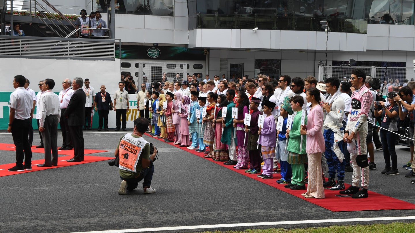 National Anthem is observed on the grid at Formula One World Championship, Rd15, Malaysian Grand Prix, Race, Sepang, Malaysia, Sunday 1 Octoberr 2017. © Mark Sutton/Sutton Images