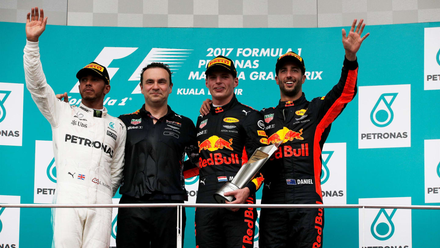 (L to R): Lewis Hamilton (GBR) Mercedes AMG F1, race winner Max Verstappen (NED) Red Bull Racing and Daniel Ricciardo (AUS) Red Bull Racing celebrate on the podium at Formula One World Championship, Rd15, Malaysian Grand Prix, Race, Sepang, Malaysia, Sund