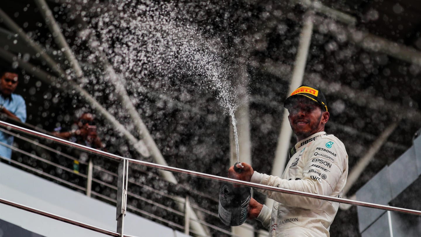 Lewis Hamilton (GBR) Mercedes AMG F1 celebrates with the champagne on the podium at Formula One World Championship, Rd15, Malaysian Grand Prix, Race, Sepang, Malaysia, Sunday 1 October 2017. © Kym Illman/Sutton Images