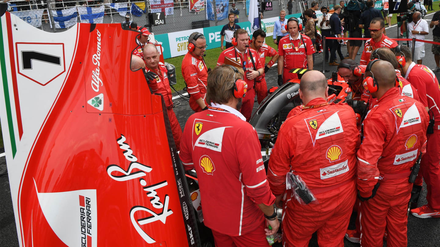 Ferrari attend to a problem on the car of Kimi Raikkonen (FIN) Ferrari SF70-H on the grid at Formula One World Championship, Rd15, Malaysian Grand Prix, Race, Sepang, Malaysia, Sunday 1 October 2017. © Mark Sutton/Sutton Images