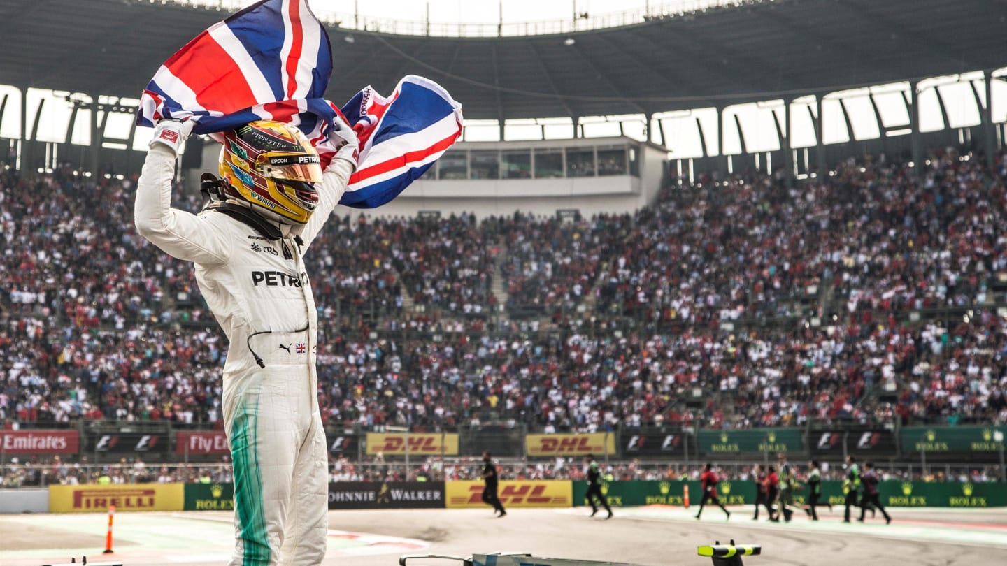 World Champion Lewis Hamilton (GBR) Mercedes AMG F1 celebrates in parc ferme with the Union Jack