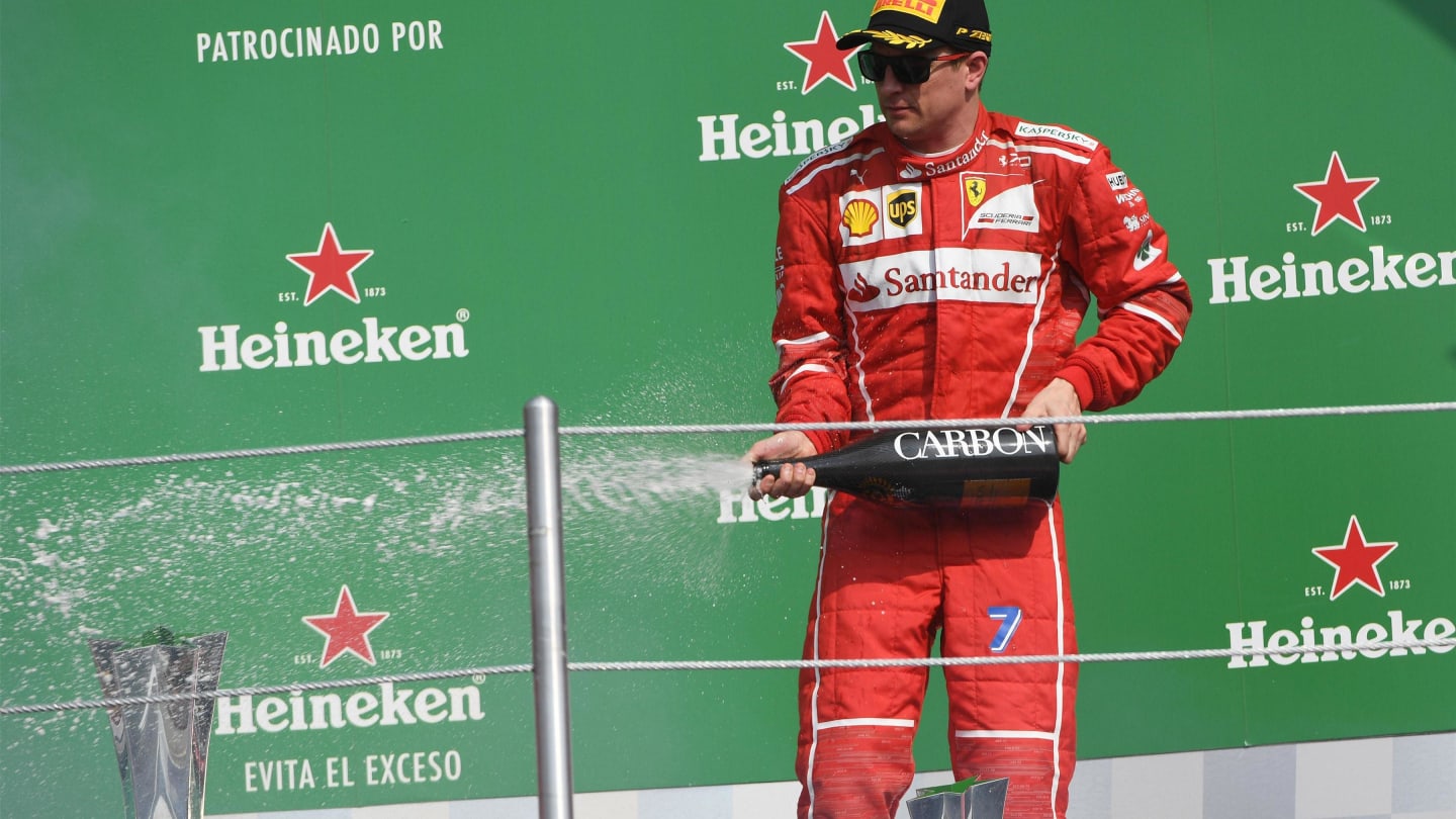 Kimi Raikkonen (FIN) Ferrari celebrates on the podium with the champagne at Formula One World