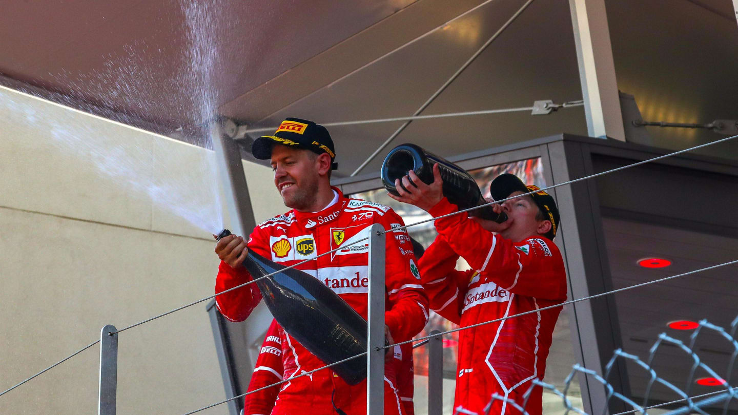 Race winner Sebastian Vettel (GER) Ferrari and Kimi Raikkonen (FIN) Ferrari celebrate on the podium
