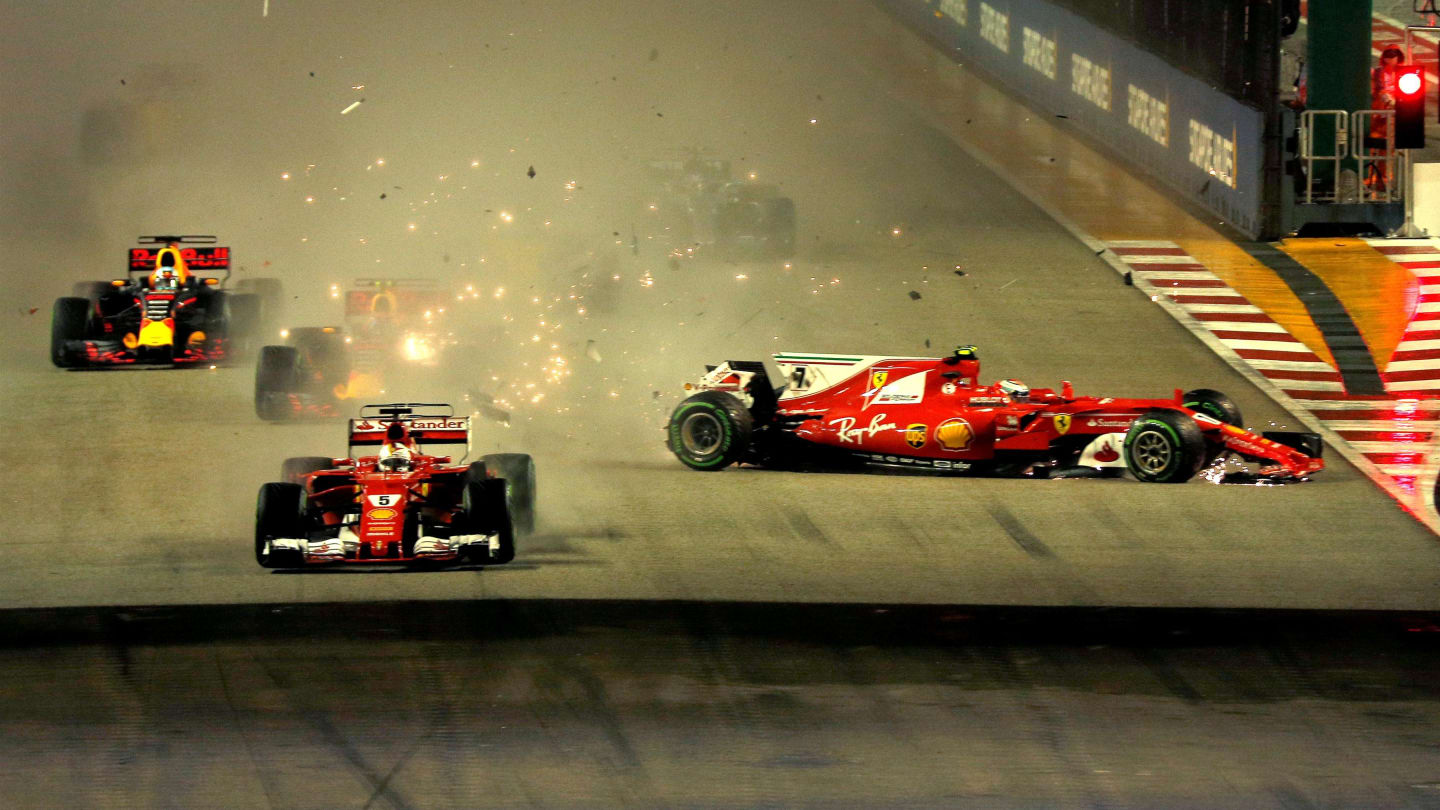 Sebastian Vettel (GER) Ferrari SF70-H leads at the start of the race and the cars of Kimi Raikkonen (FIN) Ferrari SF70-H and Max Verstappen (NED) Red Bull Racing RB13 crash after colliding at Formula One World Championship, Rd14, Singapore Grand Prix, Rac
