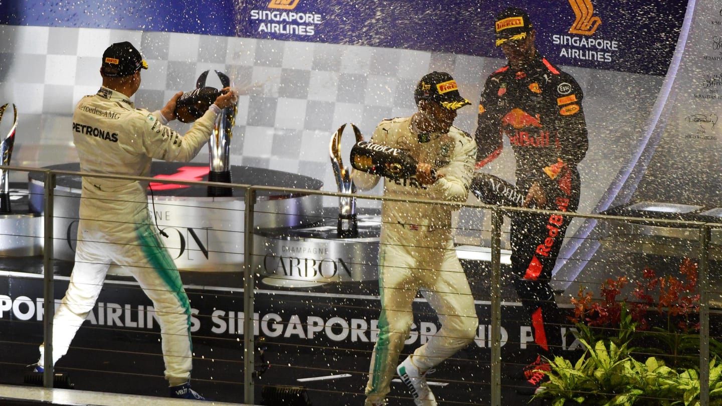 Daniel Ricciardo (AUS) Red Bull Racing, Lewis Hamilton (GBR) Mercedes AMG F1 and Valtteri Bottas (FIN) Mercedes AMG F1 celebrate on the podium with the champagne at Formula One World Championship, Rd14, Singapore Grand Prix, Race, Marina Bay Street Circuit, Singapore, Sunday 17 September 2017. © Sutton Images
