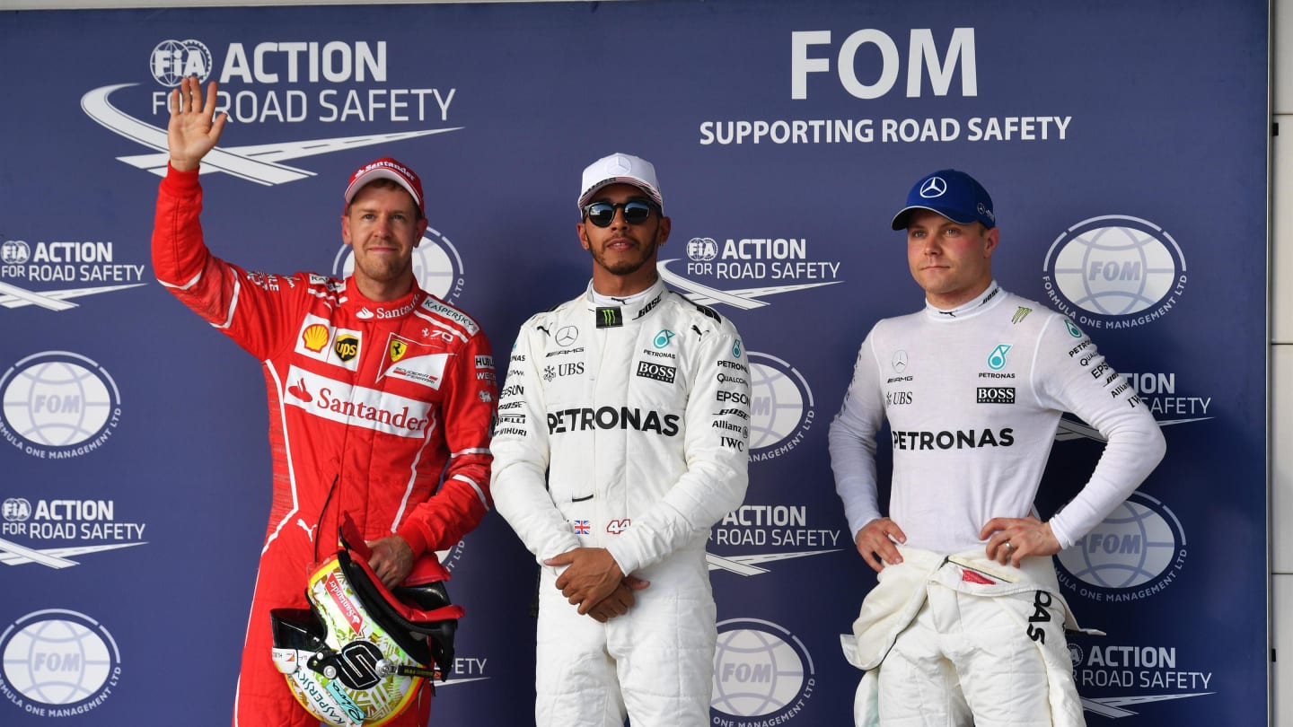 (L to R): Sebastian Vettel (GER) Ferrari, pole sitter Lewis Hamilton (GBR) Mercedes AMG F1 and