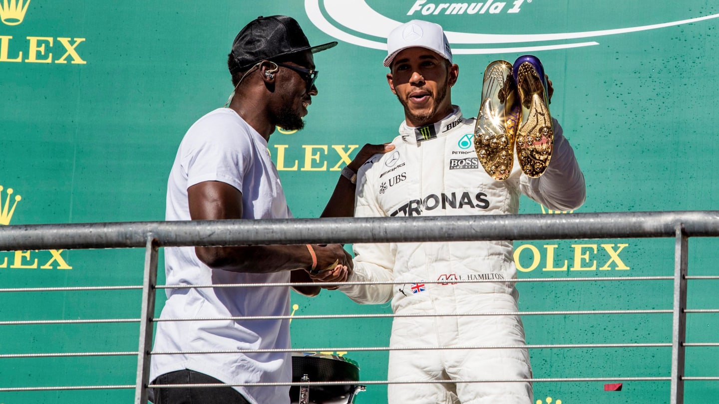Race winner Lewis Hamilton (GBR) Mercedes AMG F1 celebrates on the podium with the running shoes of