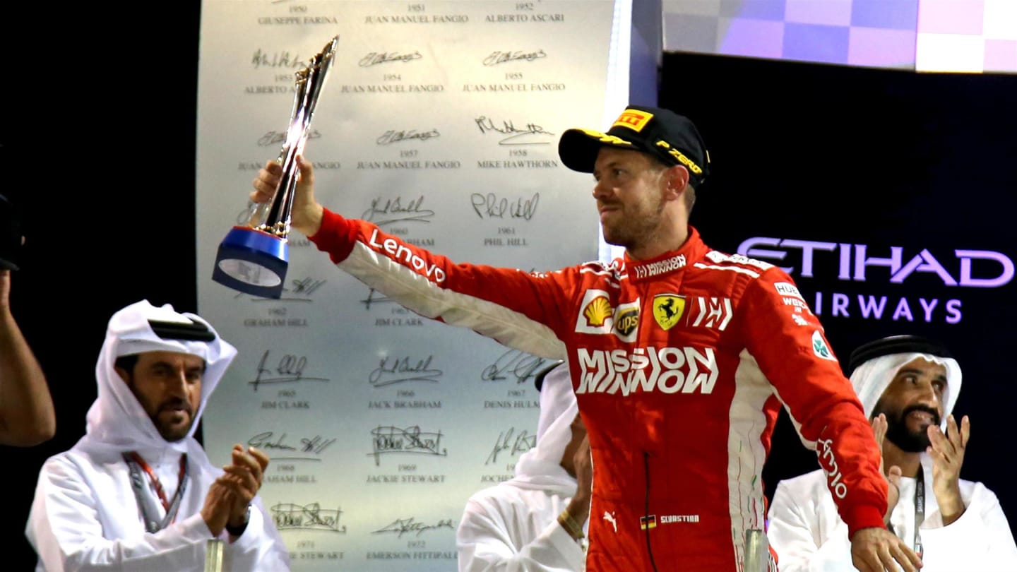 Sebastian Vettel, Ferrari celebrates on the podium with the trophy at Formula One World