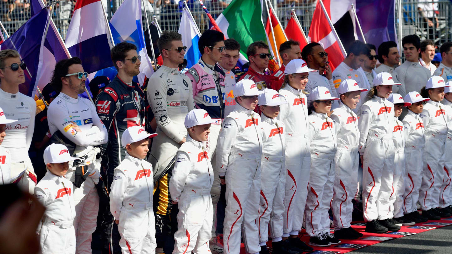 Drivers and grid kids observe the National Anthem on the grid at Formula One World Championship, Rd1, Australian Grand Prix, Race, Melbourne, Australia, Sunday 25 March 2018. © Jerry Andre/Sutton Images