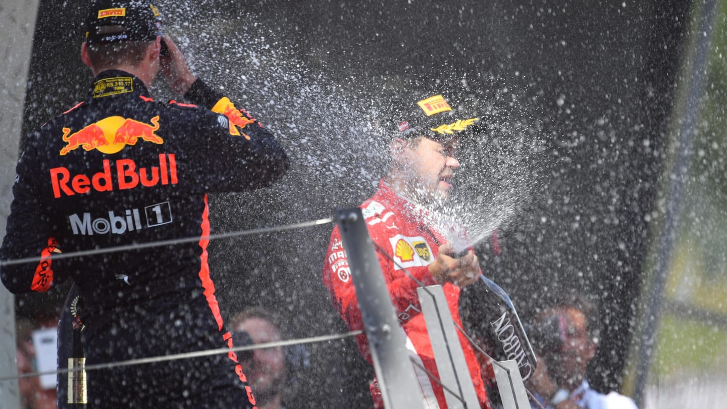 Max Verstappen (NED) Red Bull Racing and Sebastian Vettel (GER) Ferrari celebrate on the podium with the champagne at Formula One World Championship, Rd9, Austrian Grand Prix, Race, Spielberg, Austria, Sunday 1 July 2018. © Jerry Andre/Sutton Images