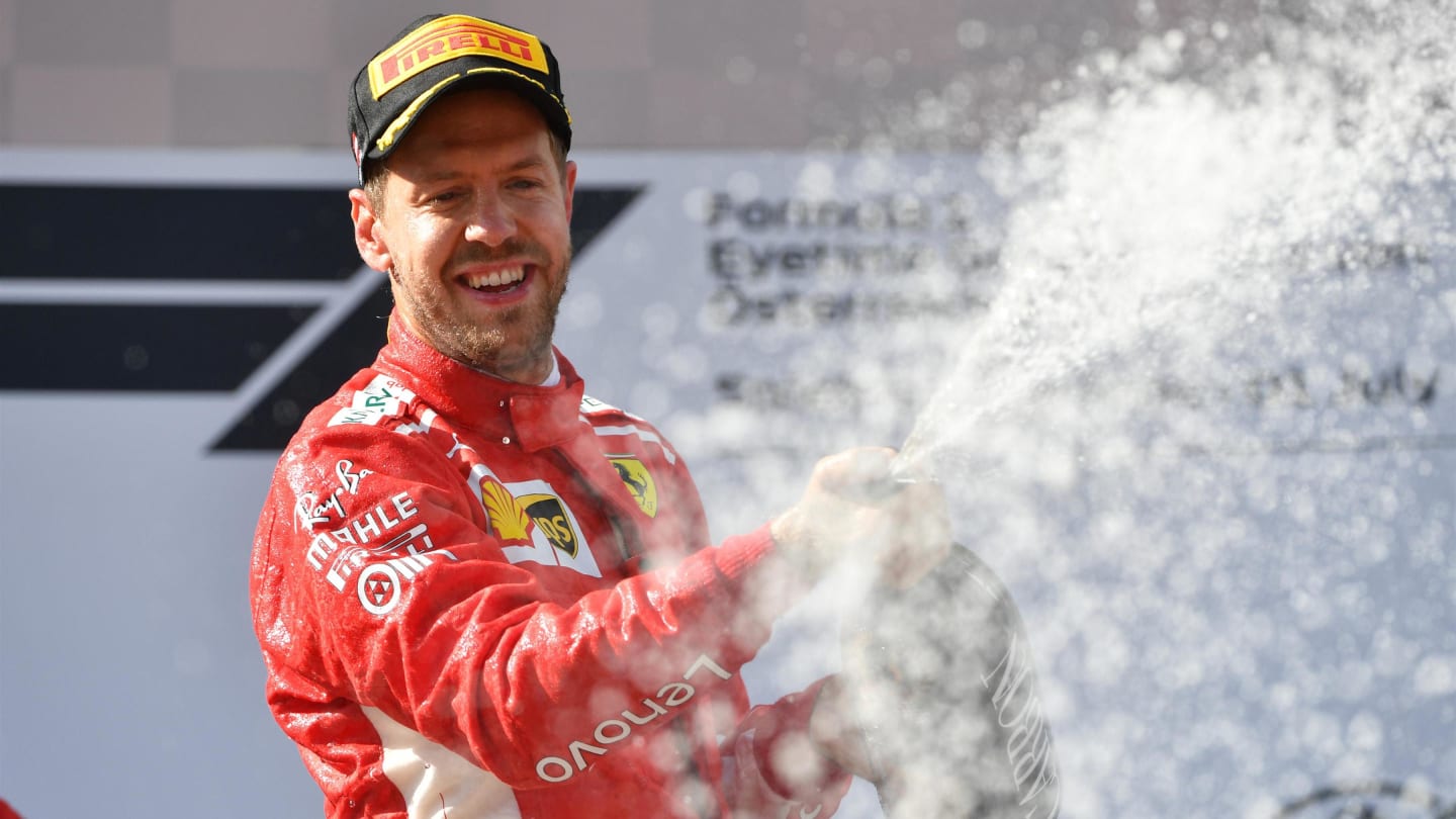 Sebastian Vettel (GER) Ferrari celebrates on the podium with the champagne at Formula One World Championship, Rd9, Austrian Grand Prix, Race, Spielberg, Austria, Sunday 1 July 2018. © Mark Sutton/Sutton Images