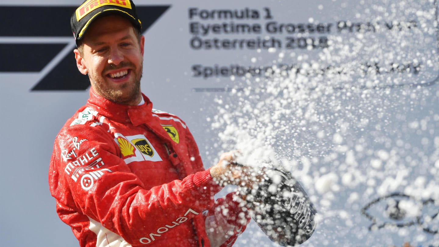 Sebastian Vettel (GER) Ferrari celebrates on the podium with the champagne at Formula One World Championship, Rd9, Austrian Grand Prix, Race, Spielberg, Austria, Sunday 1 July 2018. © Mark Sutton/Sutton Images