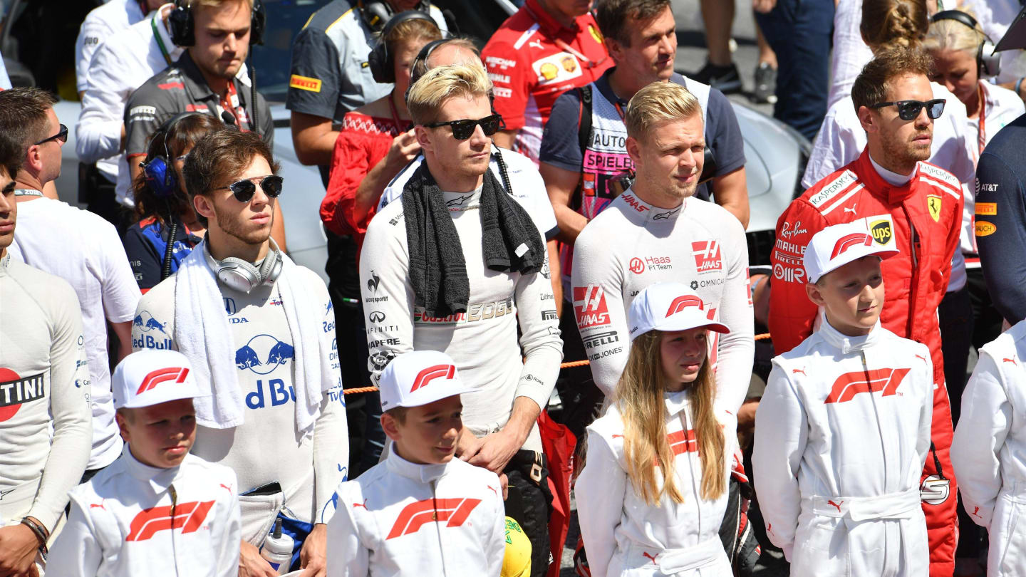 Grid kids and drivers observe the National Anthem on the grid at Formula One World Championship, Rd9, Austrian Grand Prix, Race, Spielberg, Austria, Sunday 1 July 2018. © Jerry Andre/Sutton Images